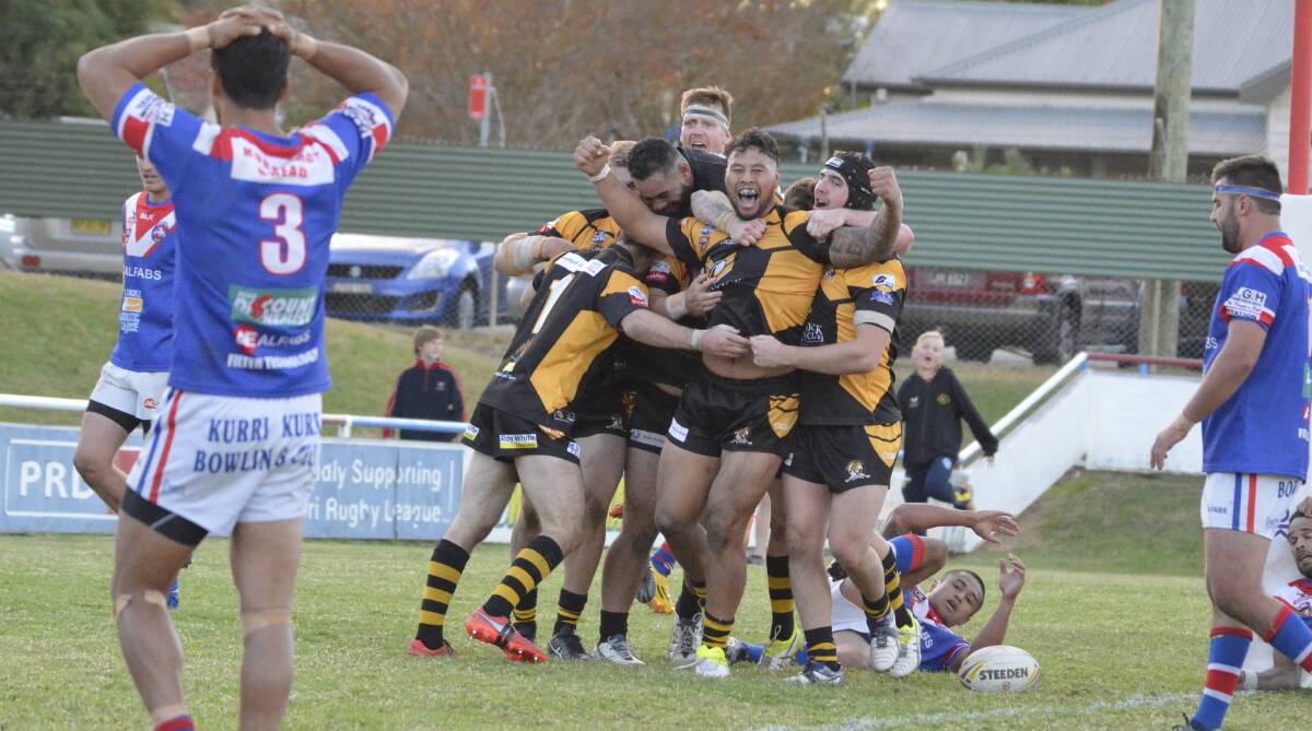 JUBILANT: Cessnock players embrace Uiti Baker after his match-winning try in the dying seconds of the game against Kurri Kurri. Picture: AMANDA HAFEY