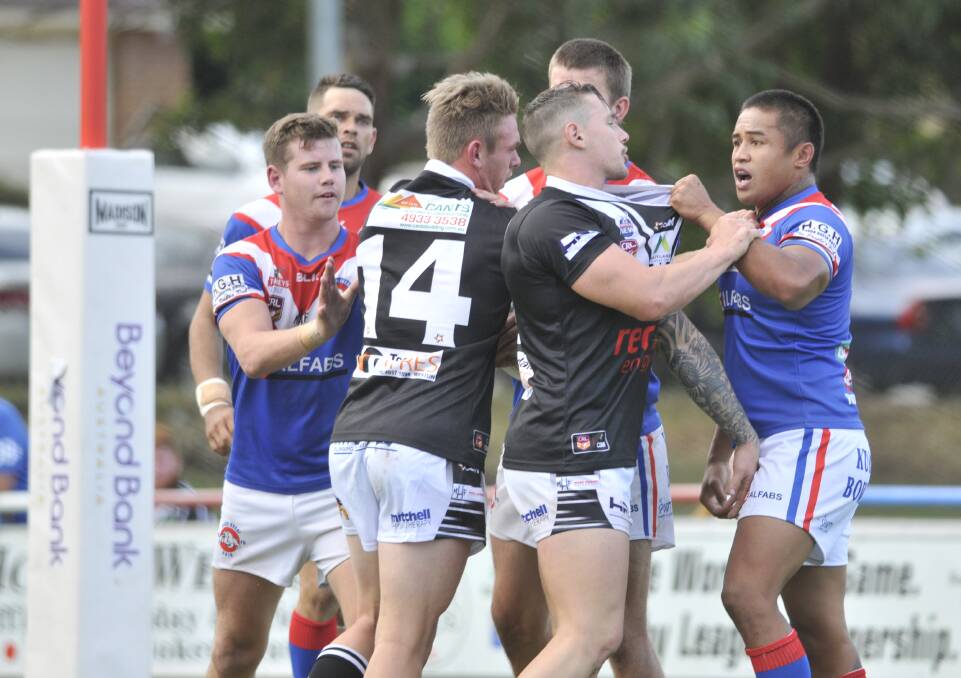 NOT ON OUR TURF: Terence Seu Seu and Maitland's George O'Brien exchange words during Saturday's often heated game between the Bulldogs and Pickers. Picture: MICHAEL HARTSHORN