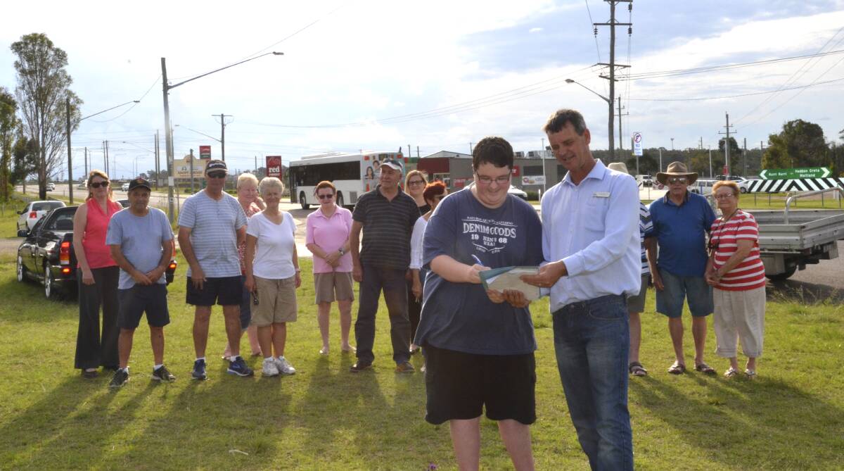 CAMPAIGN: Concerned Heddon Greta residents including Mitchell Hill, pictured at front with Cessnock councillor Darrin Gray, are supporting the petition for a formal carpark to be built at the Hunter Expressway interchange.