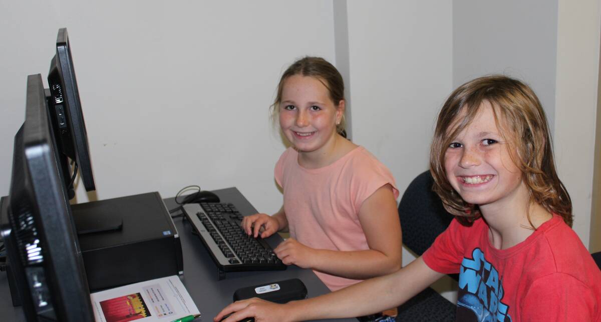 TECH-SAVVY: Hannah and Jonah Low taking part in Code Club at Cessnock Library on Tuesday.