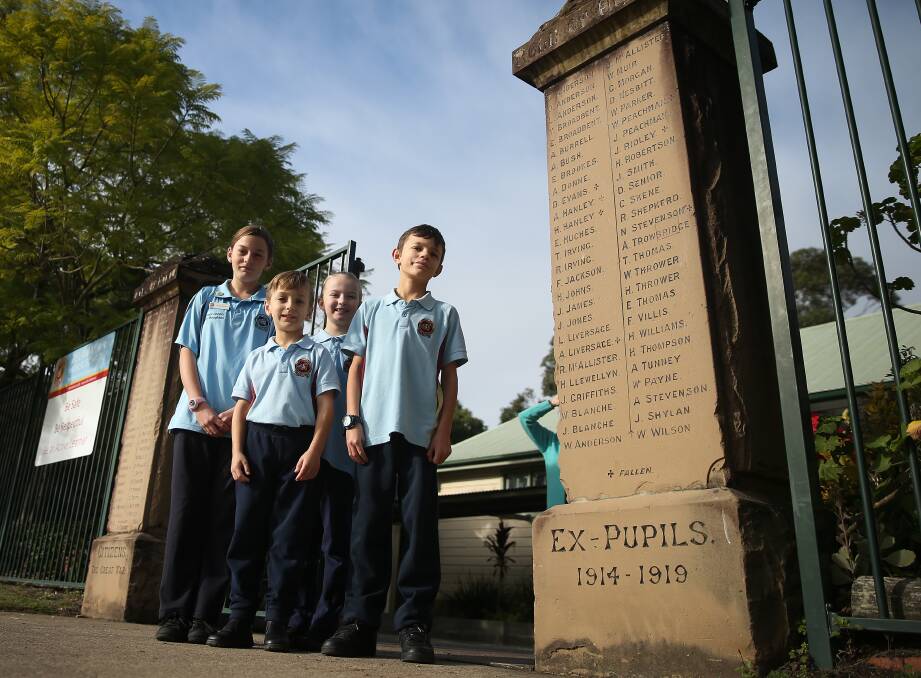 TRIBUTE: Pelaw Main Public School students Amy Boughton, Kye Boughton, Hayley Robertson and Caleb Jenkins at the World War I memorial gates. Picture: Marina Neil