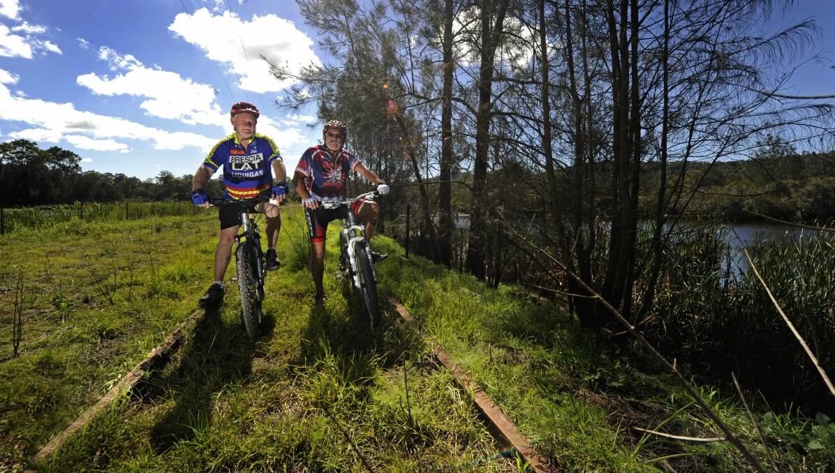 GEARING UP: David Atkinson and Billy Metcalfe on part of the alignment that will form the Richmond Vale Rail Trail. Picture: MARINA NEIL