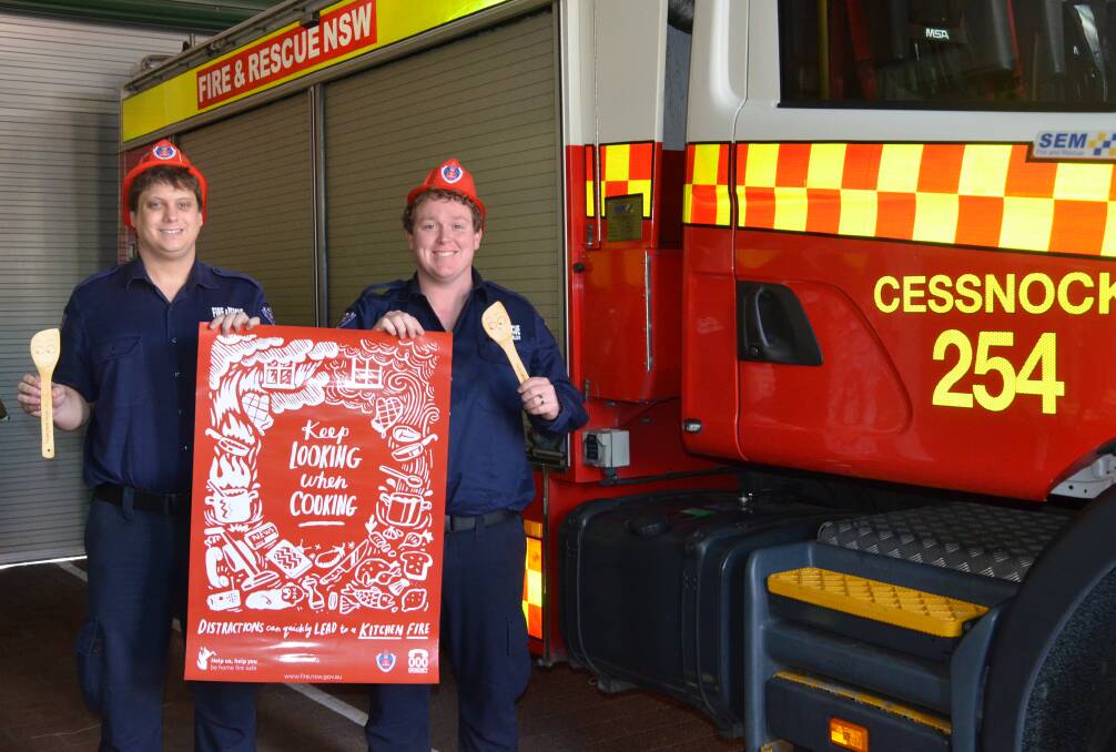 AWARENESS: Cessnock firefighters Jamie Chapple and Ben Allen with a poster promoting the theme of this year's open day back in May. Picture: Krystal Sellars