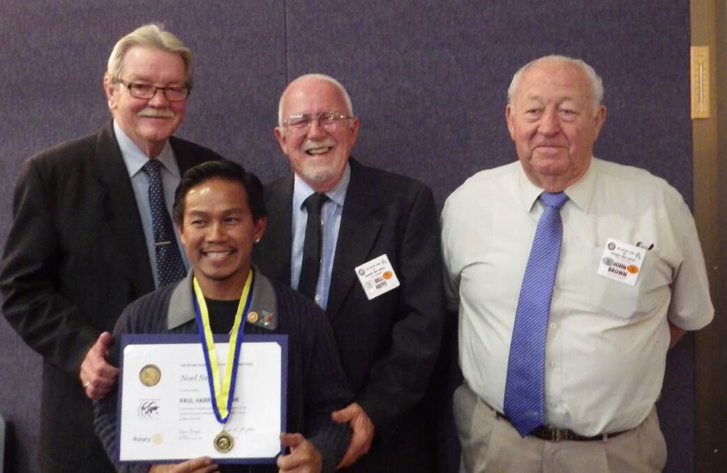 FINAL MEETING: Cessnock Wine Country Rotary Club treasurer Bruce Wilson, president Bill Hoye and secretary John Brown with member Noel Sugui (front) who was honoured with Rotary’s highest award, a Paul Harris Fellowship. Picture: supplied
