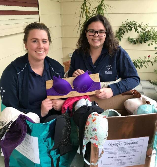 SUPPORT: Lauren Gray and Aimee Watkins with the Bra Cup, which Hunter River Division and Coastal Valleys Region Olaves won for collecting the most bras last year.