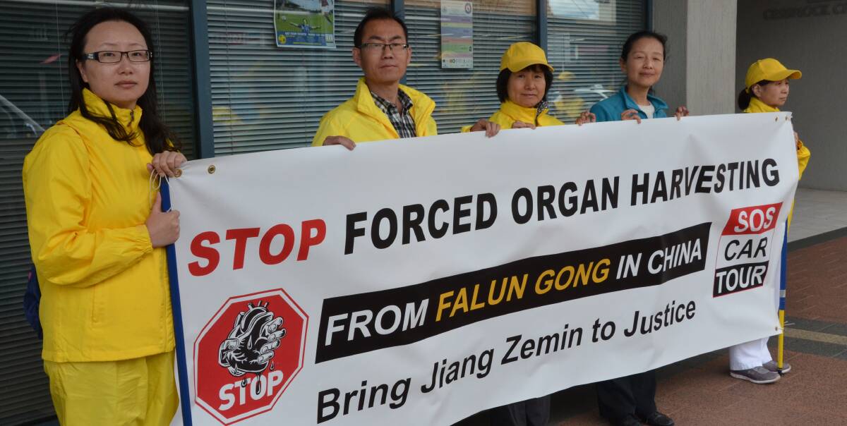HORROR: Some of the Falun Gong practitioners who are travelling around Australia to raise awareness of their persecution in China.