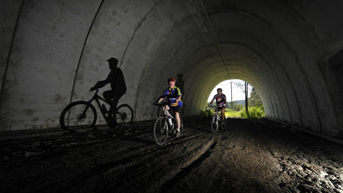LINK: Pictured in 2013, David Atkinson of Aberglasslyn and Billy Metcalfe of Kurri Kurri cycling on the old Richmond Vale Railway line. Picture: Marina Neil