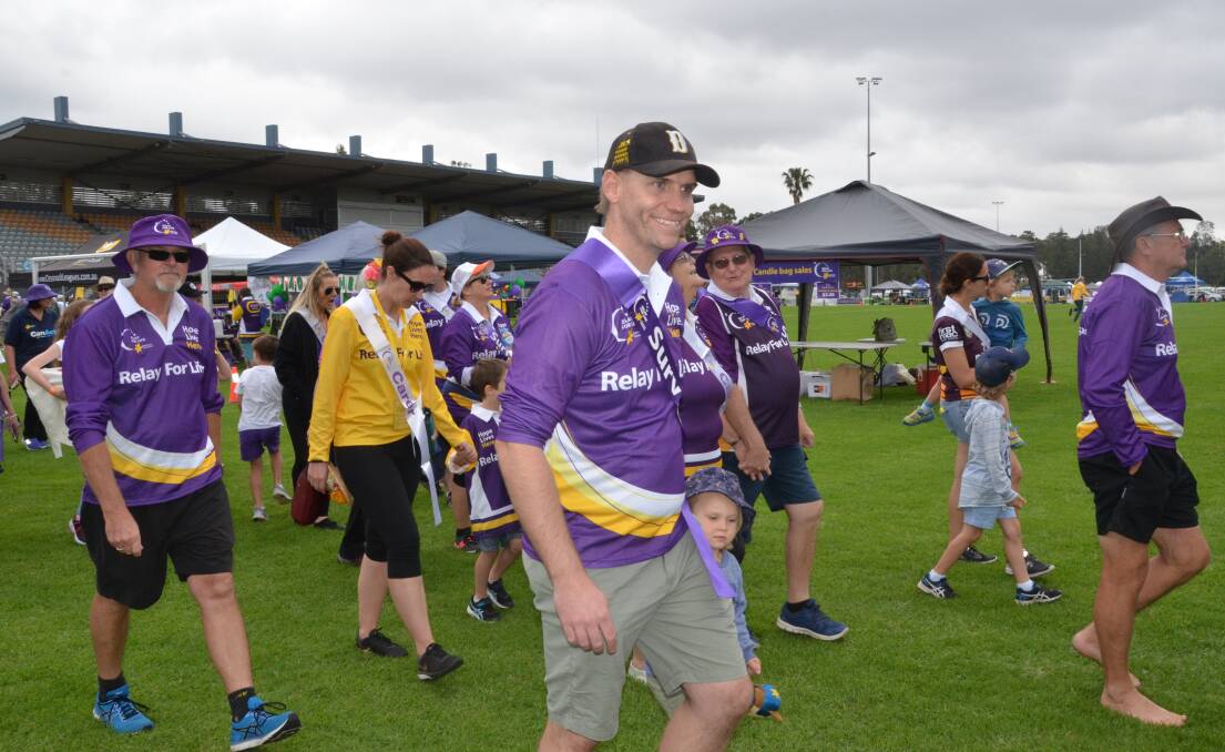 EMOTIONAL: Liam Woods walks in the survivors and carers lap at the 2017 Cessnock Relay For Life.