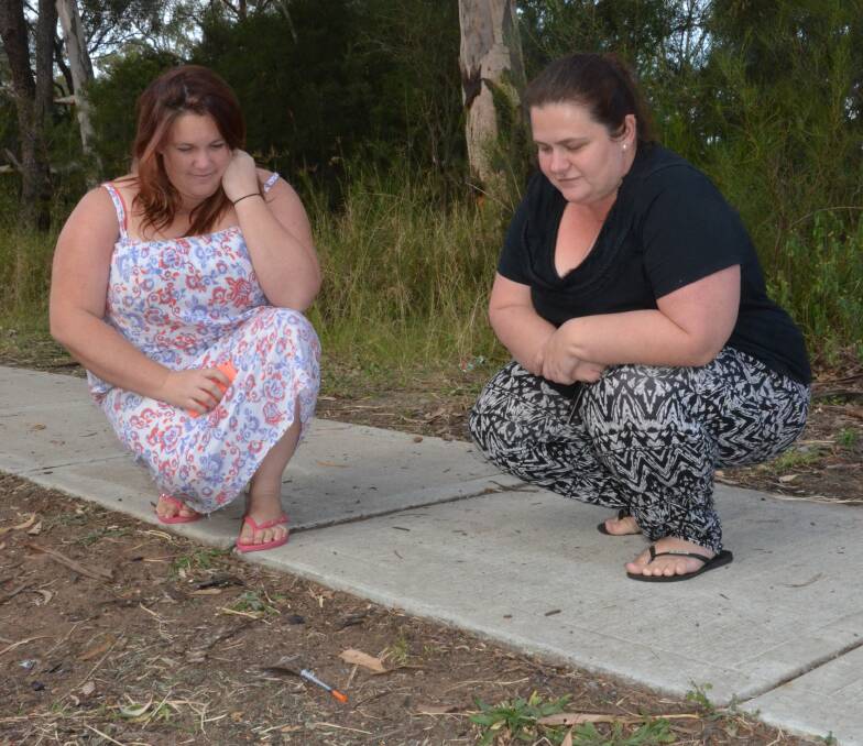 DANGER: East Cessnock residents Chantelle Moffet and Stephanie Ekert are disgusted by the amount of needles they have found on Old Maitland Road in recent weeks. Picture: Krystal Sellars