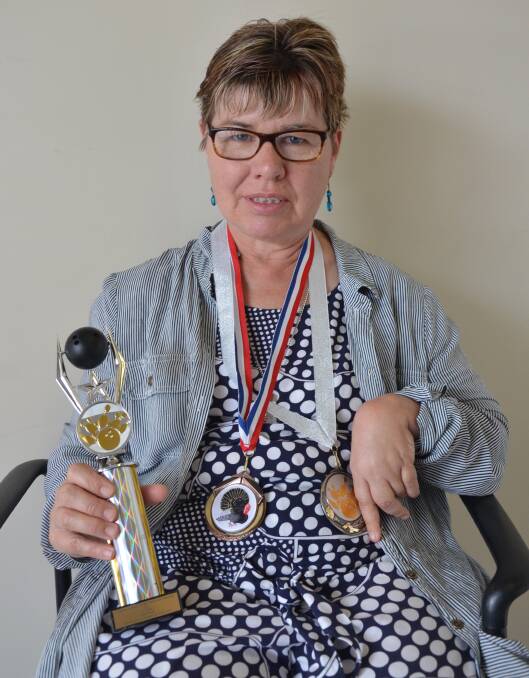 GREAT EFFORT: Mary Marks with her latest trophy and medals from ten pin bowling.