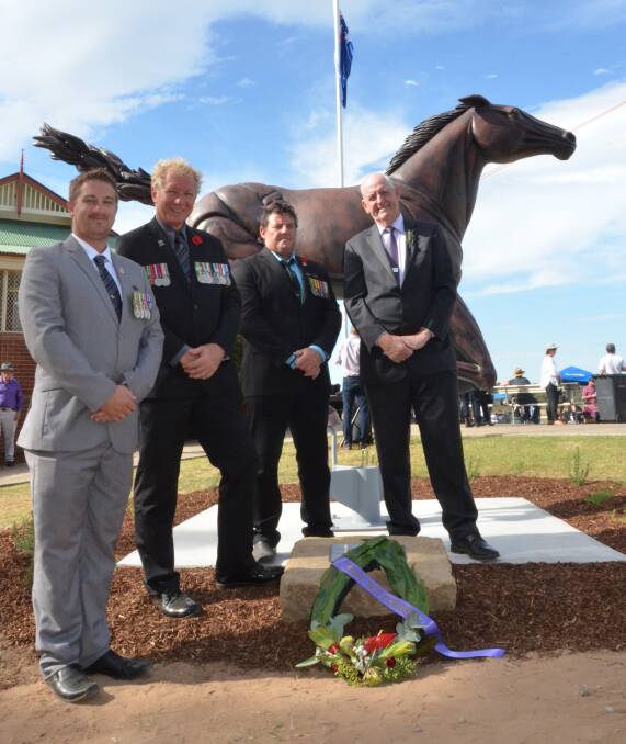 TRIBUTE: Stewart Sherman, Dan Jeffery and Craig Blue, from Soldier On, and Newcastle Jockey Club chairman Geoff Barnett after the war horse statue was unveiled at Cessnock Racecourse on Anzac Day. Picture: Krystal Sellars