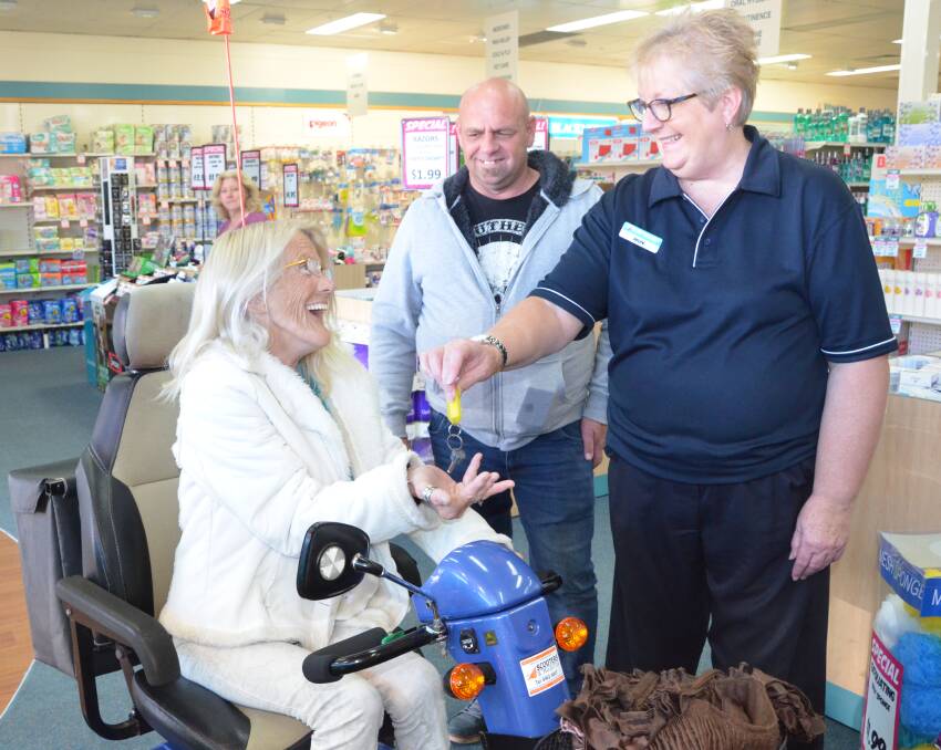 KIND ACT: Lesley Atkinson receives her new scooter at Your Discount Chemist Kurri, pictured with Steve Parnell and chemist retail manager Helen Hardimon.