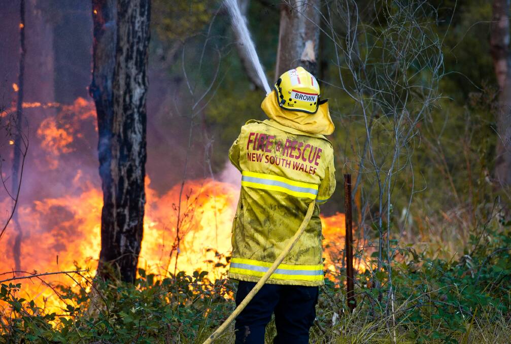 HEROIC: A firefighter works to contain a blaze near Abermain in December. Picture: Perry Duffin