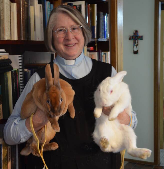 FURRY FRIENDS: Anglican Parish of Mount Vincent and Weston parish priest, Mother Theresa Angert-Quilter with the parish rabbits, Whitby and Hilda. Picture: Krystal Sellars