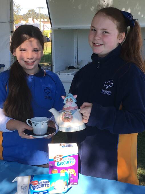 UNIQUE ITEMS: Kurri Kurri Girl Guides Chloe and Maddison with a teapot that will be for sale at the Guides' garage sale this Saturday. Picture: supplied