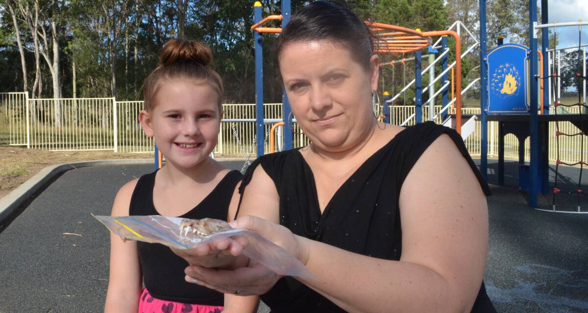SCARE: Paryss Morton, 10, of Millfield and her mum Sonya with the bat skull Paryss stood on at Crawfordville Park. Picture: KRYSTAL SELLARS