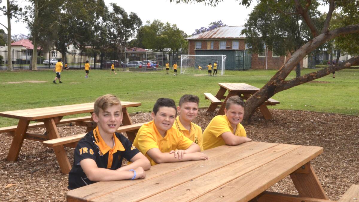 GREAT ADDITION: Cessnock Public School students Dominic Houle, Preston Keppie, Micheal Kolokotas and Harrison McEwan at one of the new tables was installed as part of the playground upgrade inititiave. Picture: Krystal Sellars