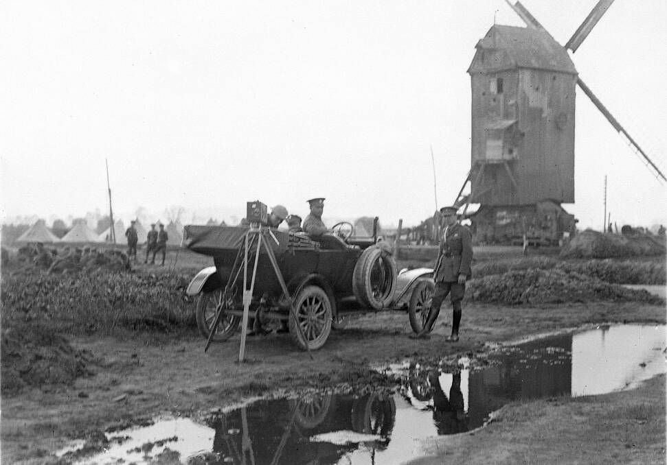 INTREPID: Captain Frank Hurley (right) with his photographic equipment and driver in Belgium September 14, 1917. Picture: AWM E01995