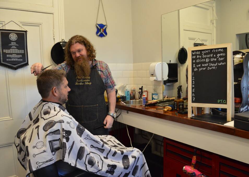 GOOD FIT: Steff Gilmartin from the Hairy Scotsman cuts James Morley's hair at the barber shop's new home, the Caledonia Hotel at Aberdare.