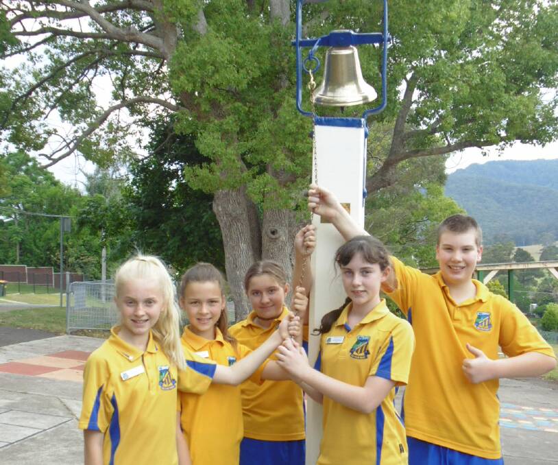 GIFT: Mulbring Public School Year 6 students Jayde Webster, Imogen Davies, Grace Murray, Andrea Pinchen and Archer Harvey with the restored bell. Absent: Immogen Shortland, Scarlett Henning and Sophie Andrews.