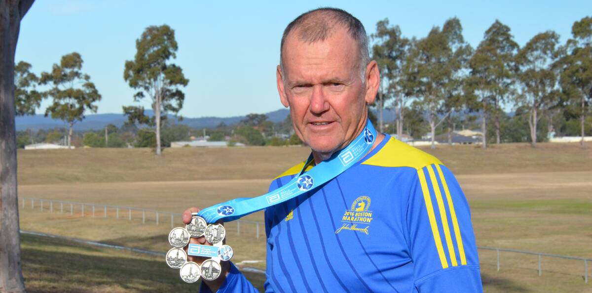 ACHIEVEMENT: Cessnock's Ian Olsen with the medal he received for completing the six Abbott World Marathon Majors (New York, Chicago, Berlin, London, Boston and Tokyo). Picture: KRYSTAL SELLARS
