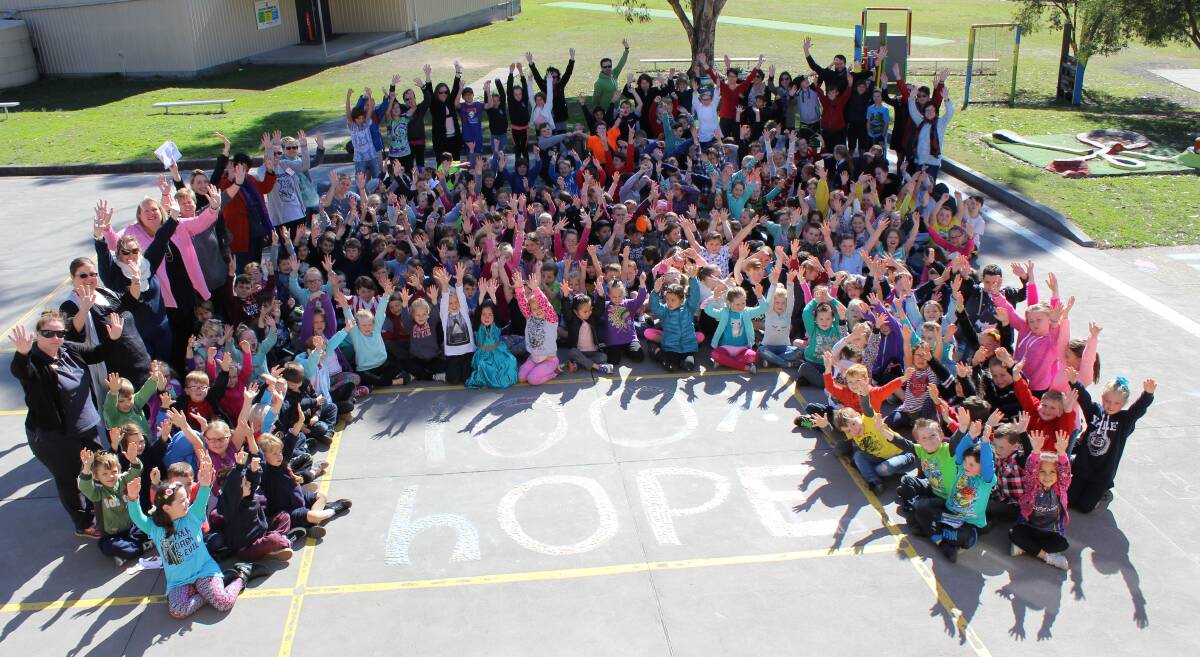 SPREADING HOPE: Abermain Public School held an out-of-uniform day on July 26 and spelled out '100% HOPE' in coins, raising $440 for Ugandan children.