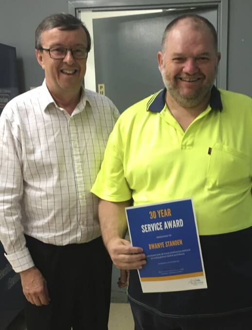 ACHIEVEMENT: Endeavour Group CEO Greg Bourke presents Cessnock Linen Service employee Dwayne Standen with his 30 years' service award. Picture: supplied