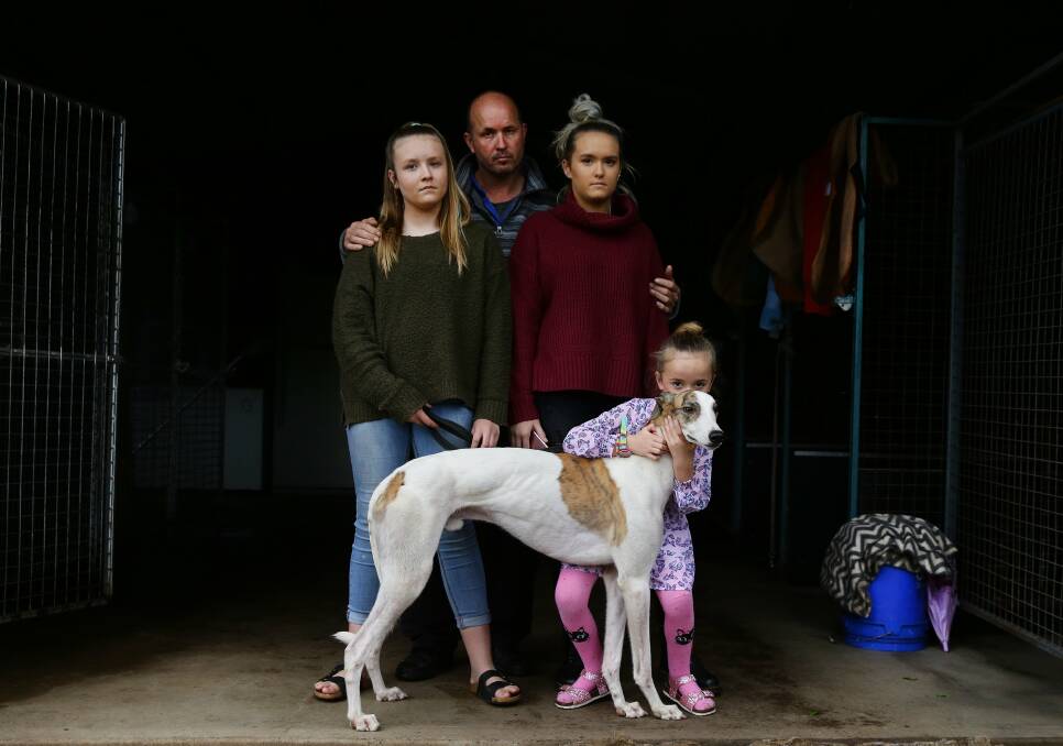 DEVASTATED: Top greyhound trainer Jason Mackay with his daughters April, Summah, Rose and dog Berzerk, after hearing of the ban. Picture: Marina Neil