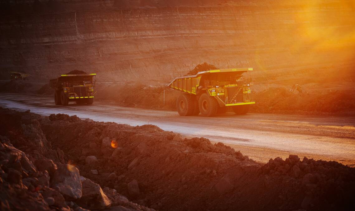 AROUND THE CLOCK: Mine trucks at BHP Billiton's Mount Arthur coal mine, where contract workers are paid substantially less than their directly employed colleagues for the same work. Picture: BHP Billiton.
