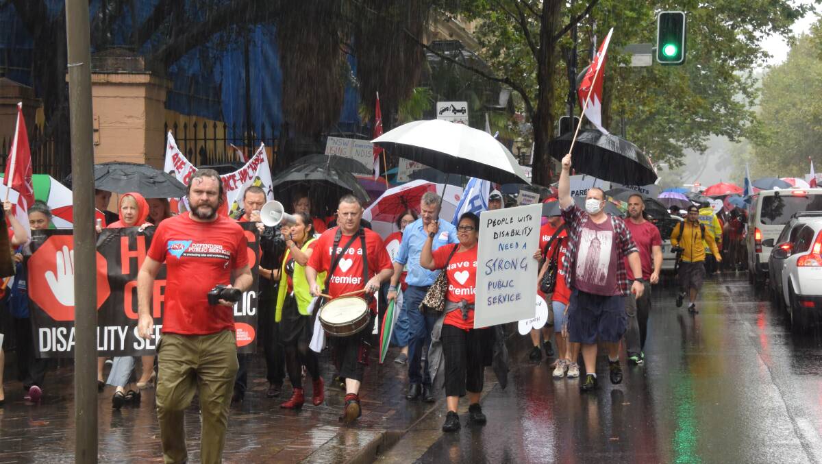 RAIN, HAIL OR SHINE: Union rally on Tuesday at Parliament House against the planned privatisation of NSW government disability services.