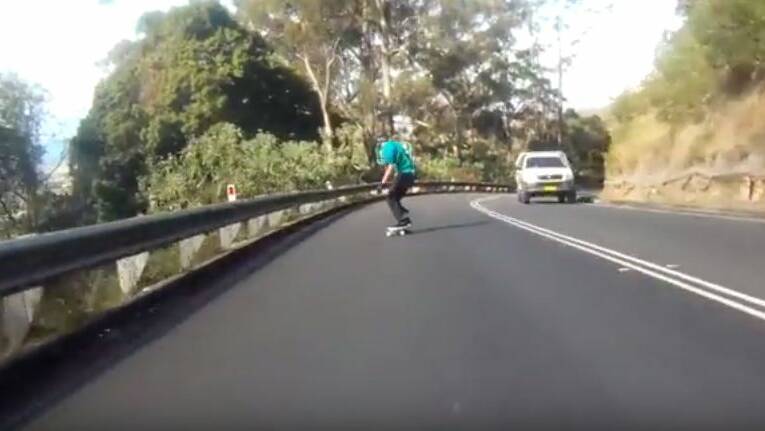 A screen grab from a video showing a skateboarder riding all the way down Bulli Pass. 
