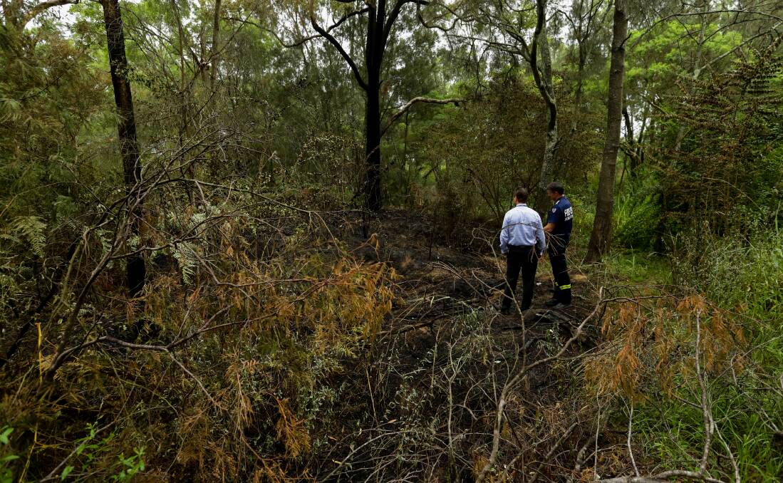 SUSPICIOUS: Forensic Police and NSW Rural Fire Service personnel inspect a fire ignition point at Chinamans Hollow. Picture: Jonathan Carroll