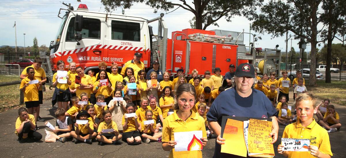 THANK YOU: NSW RFS Brigade Cessnock Central members visit Cessnock PS to accept the students' letters of thanks. Picture: Marina Neil
