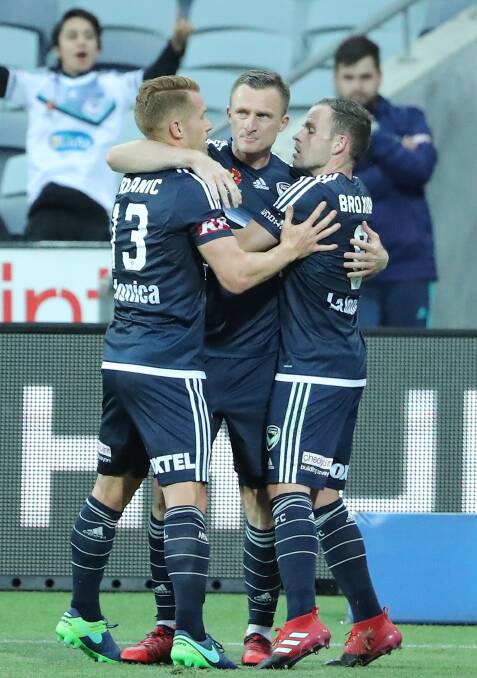 Record breaker: Victory players congratulate Besart Berisha after the striker converted from the penalty spot in the 4-2 win over the Jets. Picture: Getty Images 