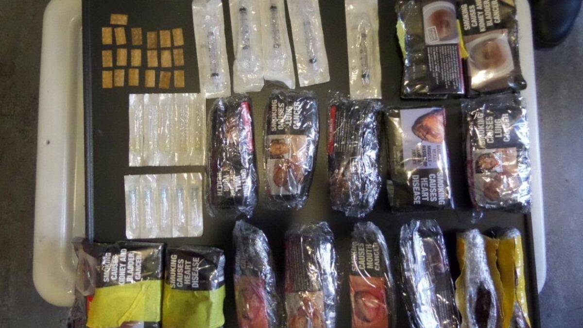SEIZED: The contraband, including 15 pouches of tobacco, found in a bin at Cessnock jail on Monday. Picture: Corrective Services NSW.