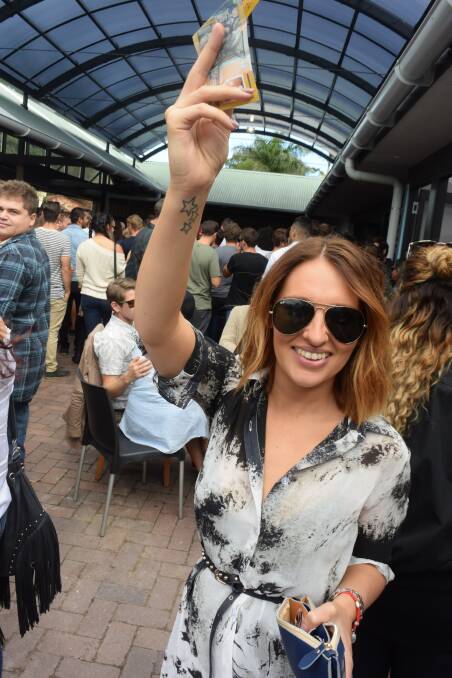 UP: Becky Rogers shows off her two-up winnings at the Cricketers Arms in Cooks Hill. Picture: Brodie Owen