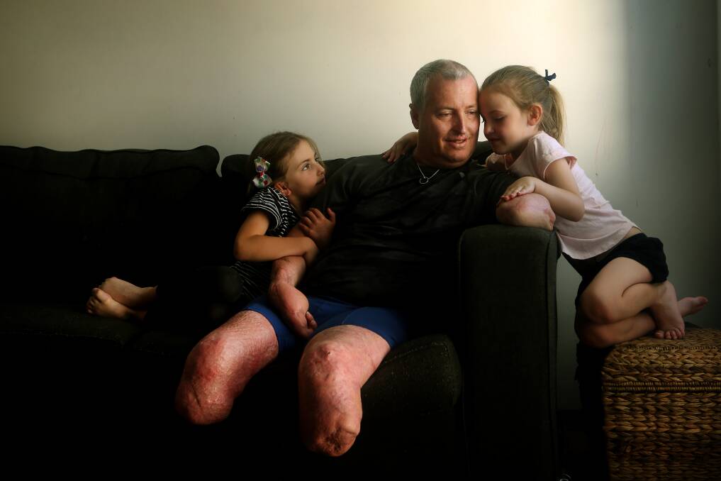 Blackbutt's Darren Harris is glad to be home with daughters London and Summer and the rest of his family. Picture: Sylvia Liber