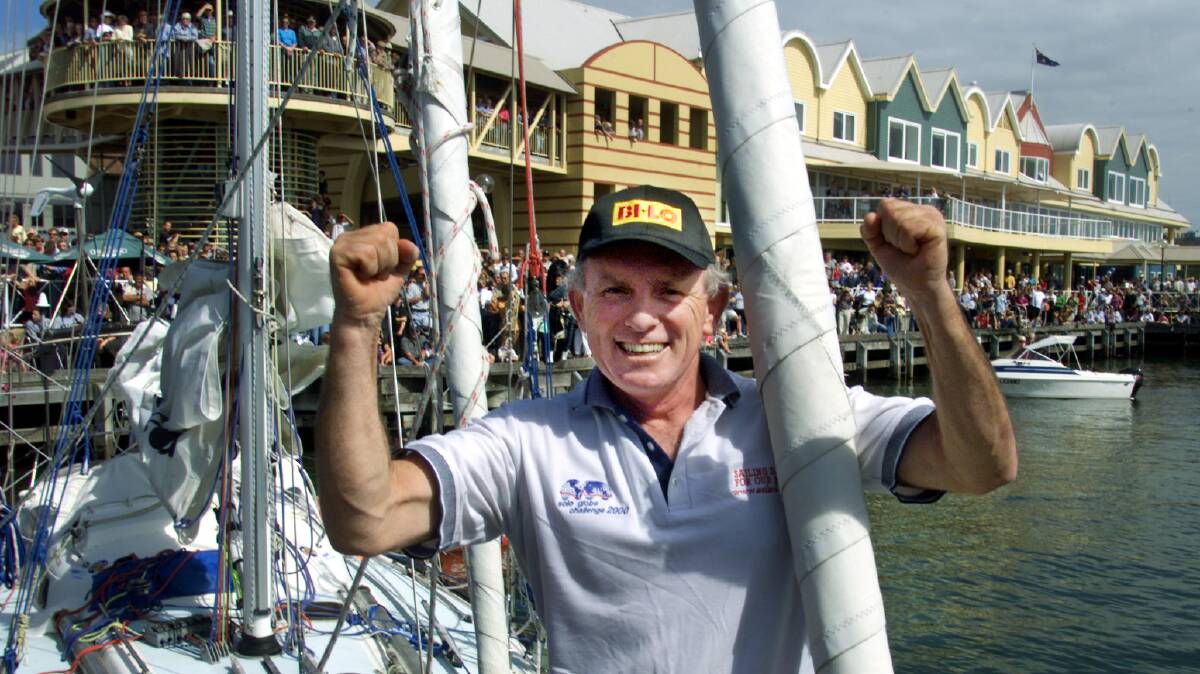 A jubilant Tony Mowbray is greeted by thousands along the Newcastle harbour foreshores as he completes his round-the-world solo voyage on April 14, 2001. Picture: Ron Bell 