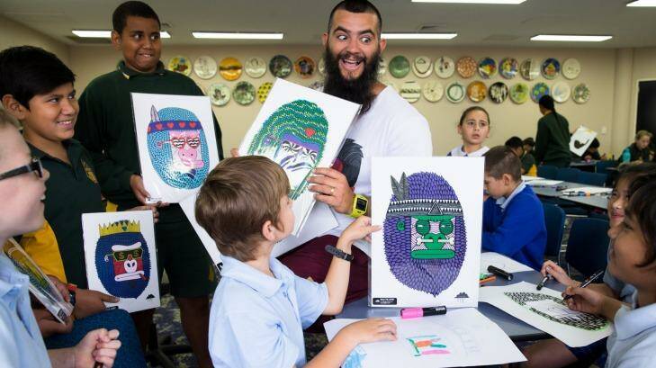 Artist Mulga fires up young imaginations during a workshop for primary school students at Liverpool Library. Photo: Janie Barrett