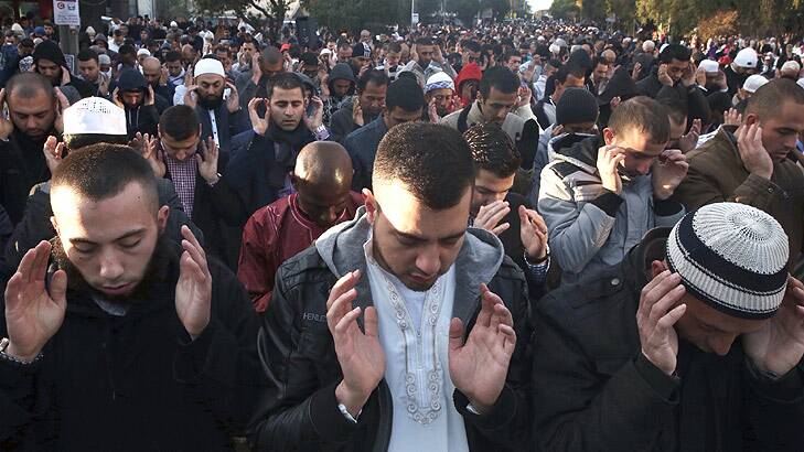 Homage: Worshippers gather outside the Lakemba mosque.