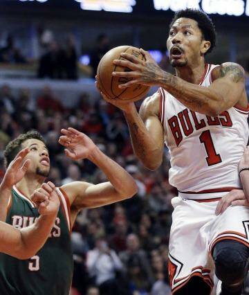 Back to his best: Chicago Bulls guard Derrick Rose drives to the basket against Milwaukee Bucks forward Ersan Ilyasova and guard Michael Carter-Williams. Photo: Nam Y. Huh