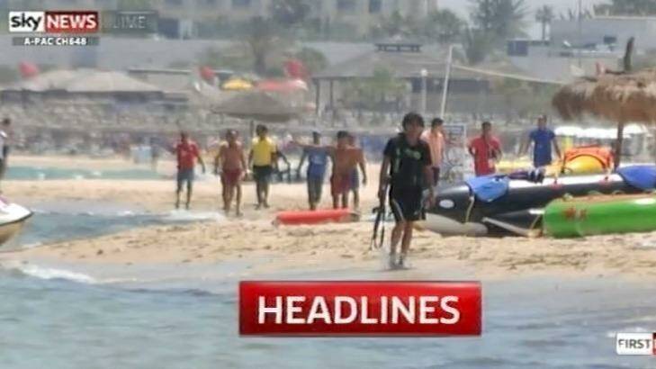 Beach massacre: Seifeddine Rezgui can be seen walking along the beach with his gun. Photo: Screen grab: Sky News