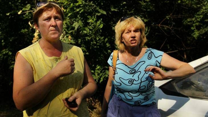 Teachers Olga Korostilenko (left) and Marina Tiheeva fleeing the shelling in Shakhtersk on Thursday. Photo: Kate Geraghty
