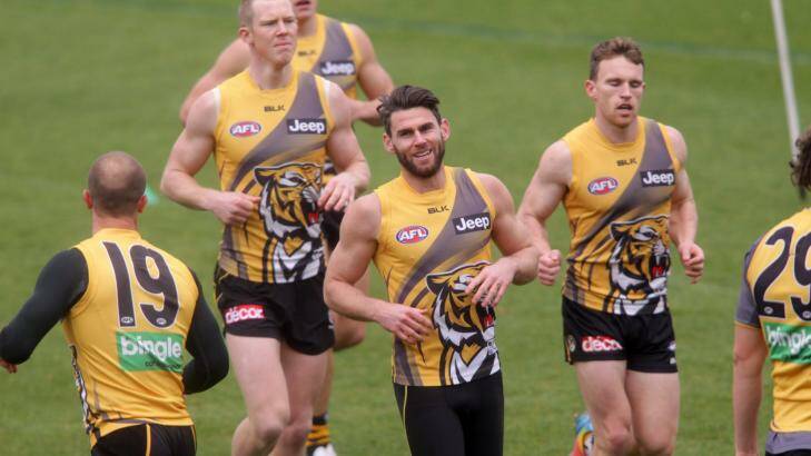 Tigers ace: Chris Newman (centre) wants to play on next year if his body allows it. Photo: Wayne Taylor