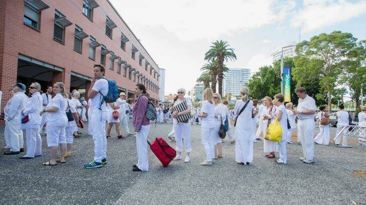 Crowds flock, dressed in white and await in line for a face-to-face encounter with controversial faith healer John Of God at Sydney's Olympic Park. Photo: Cole Bennetts