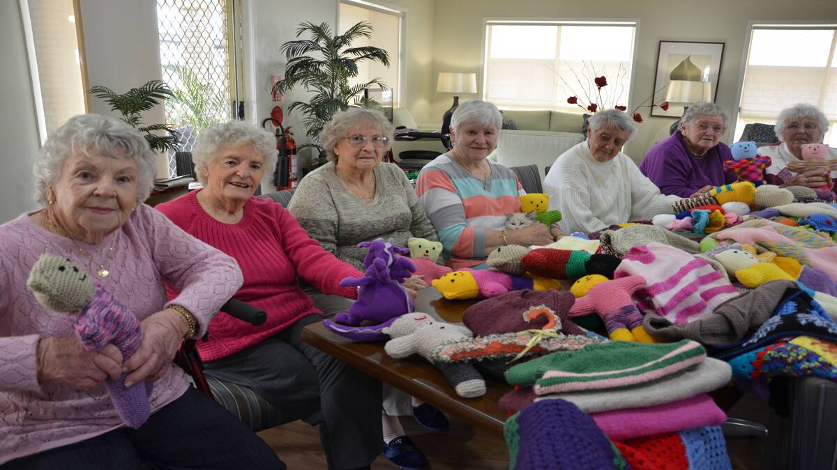 GENEROUS: Settlers Cessnock knitting group members Barbara Price, Gwen Rees, Tess Pritchard, Colleen Barrowcliff, Rhonda Sullivan, Shirley Davies and Shirley Cobby with some of the goods they have made for Jodie’s Place. (Absent: Kay Ross and Leonie.) Photo by Emily Clulow.