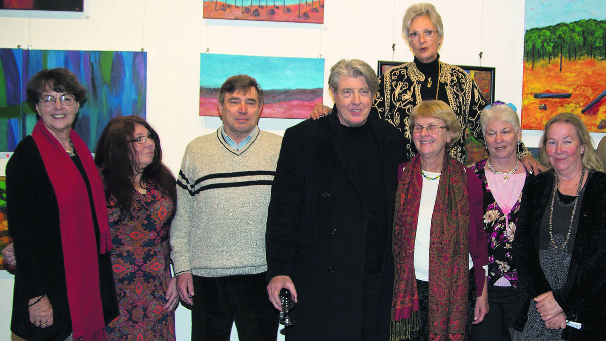 IMAGINATION: Some of the artists on the opening night of ‘Symposium’, Patricia Francis (rear) and at front from left, Gayle Banfield, Judi Stemp, Mike Fahey, Stephen James, Maureen Farrell, Peggy Parsons and Wendy Fursdon. 
