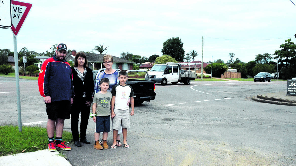 BUSY CORNER: Heddon Greta residents Matt Dimmock, Jenny Dimmock and Alison Greif, and Alison’s grandsons Ethan and Caiden Bickford at the intersection of Main Road and Young Street, where they have concerns about safety.