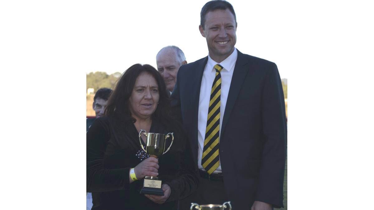 Youthful King part-owner Delice Watson accepts the trophy from Cessnock Leagues Club CEO Paul Cousins.