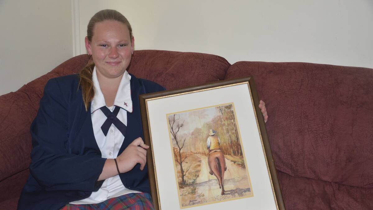 GOOD CAUSE: Lauren Ford with one of the paintings she will be raffling as part of a fundraising campaign for a trip to Uganda. 